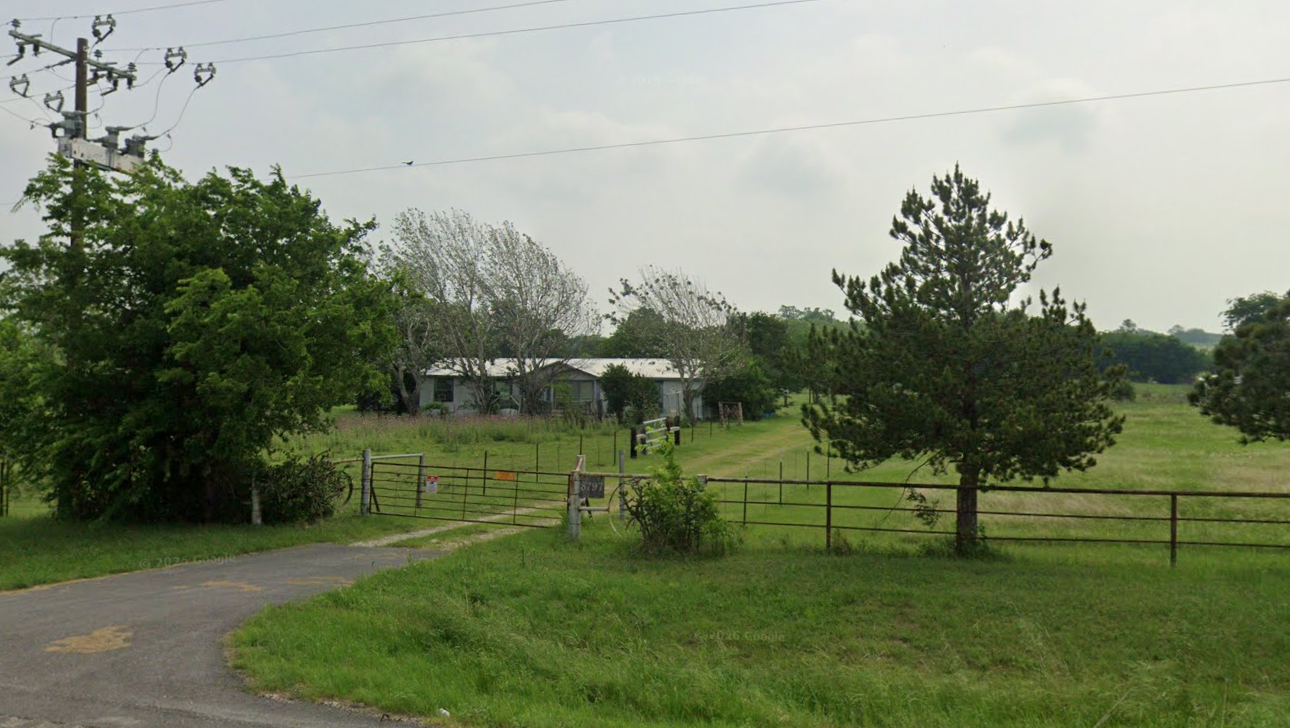 8797 FM 2450 front gate and residence